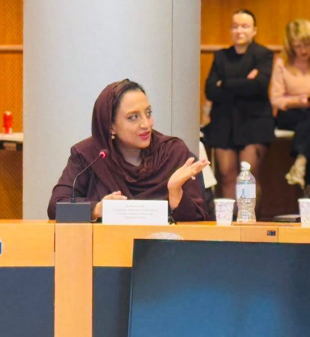 Dr. Farhat Asif speaking at the microphone at the European Parliament